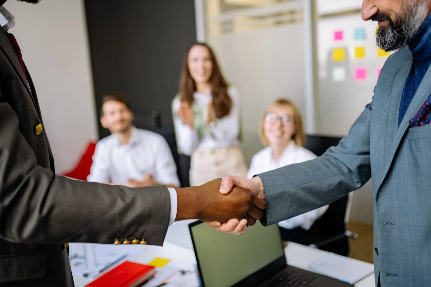 Two professionals shaking hands after a final interview
